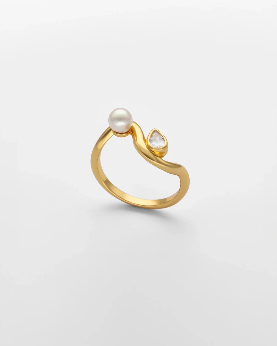 S-förmiger Ring in Seitenansicht, weißer Hintergrund, Detailaufnahme der Perle und Zirkonia.