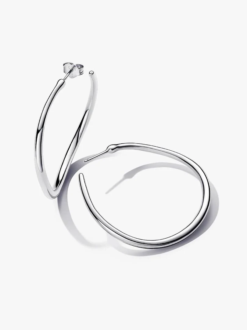 Pair of organic-shaped hoop earrings on a white background, angled view with soft shadows.