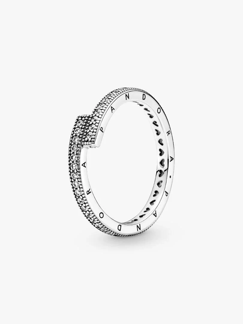 Overlapping silver ring shown at a side angle, white background, close-up of cubic zirconia pavé detail.