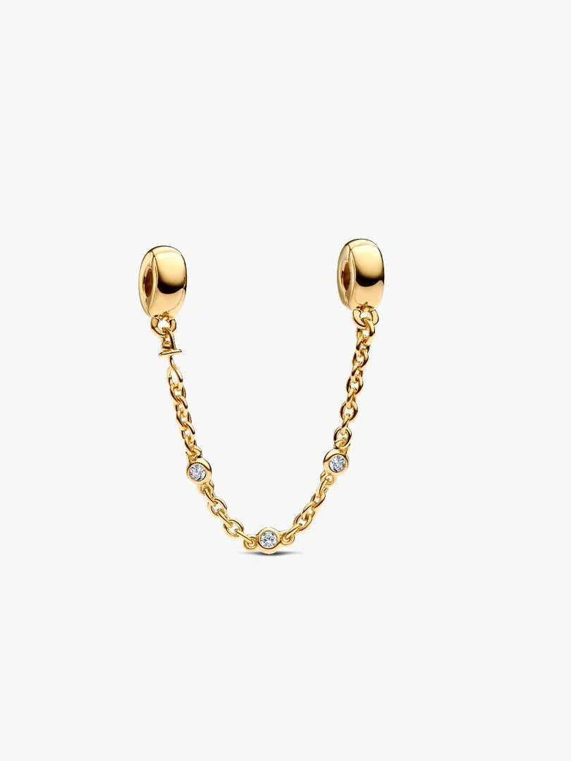 Gold safety chain with three cubic zirconia stones, front view in a curve on a white background.
