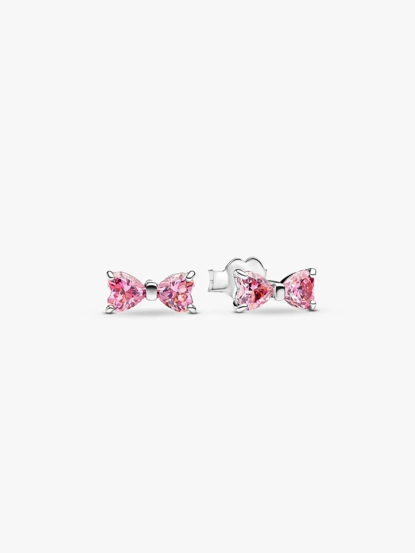 Pair of pink bow stud earrings with cubic zirconia, front and side view on white background.
