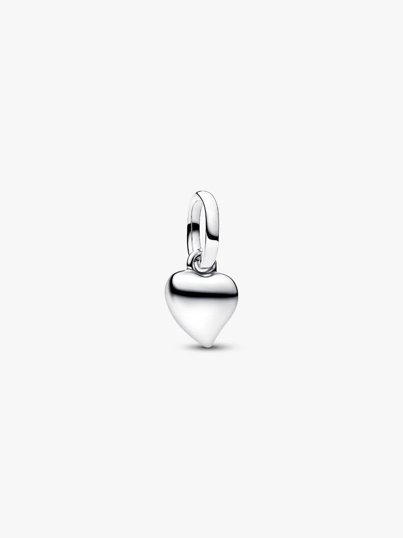 Front view of asymmetrical silver heart charm, slightly high angle on a white background.