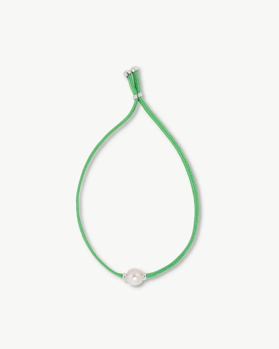 Green cord bracelet with a central white pearl, front view on a white background.
