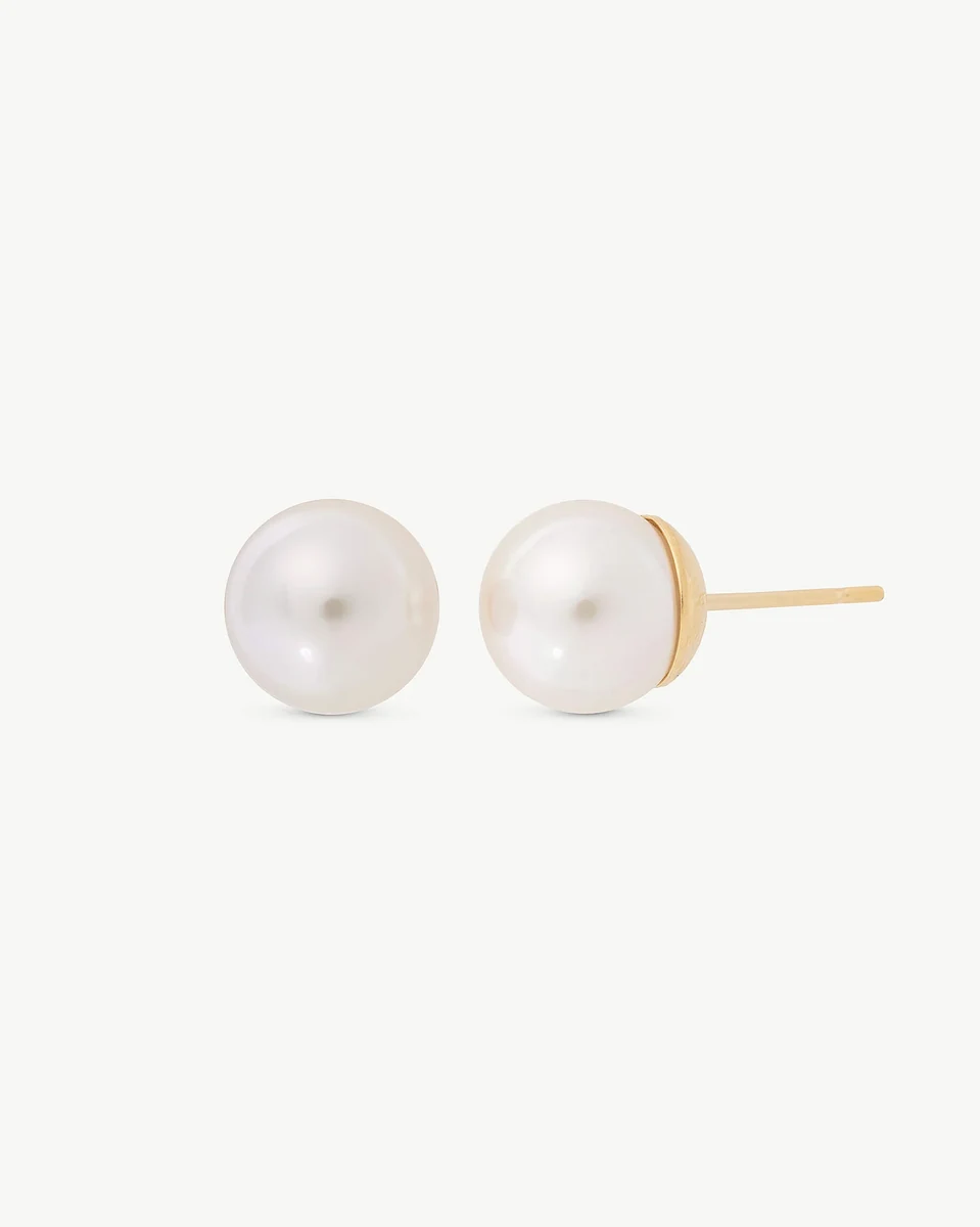 Pair of white pearl stud earrings with gold setting, front side view on a white background.