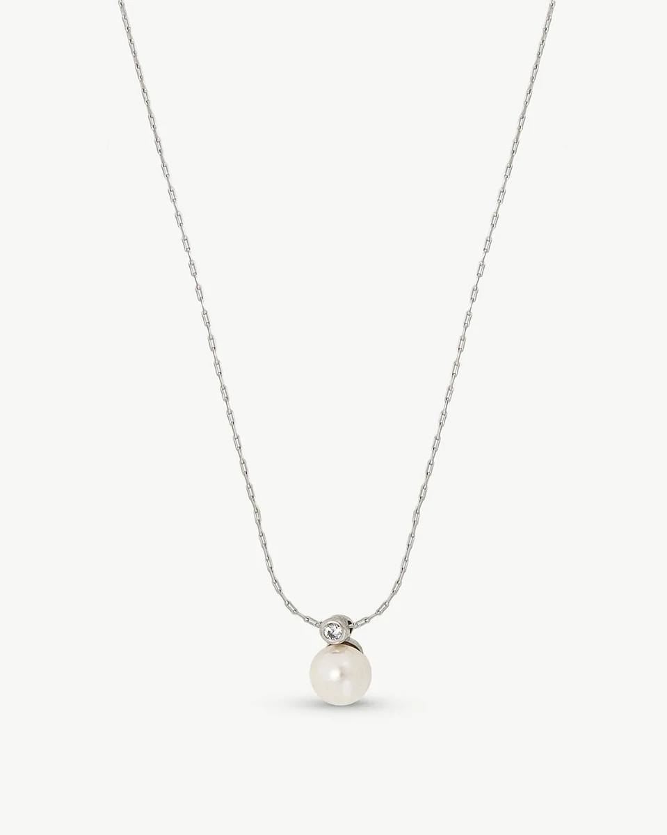 Necklace with pearl and cubic zirconia pendant, front view on a pure white background.