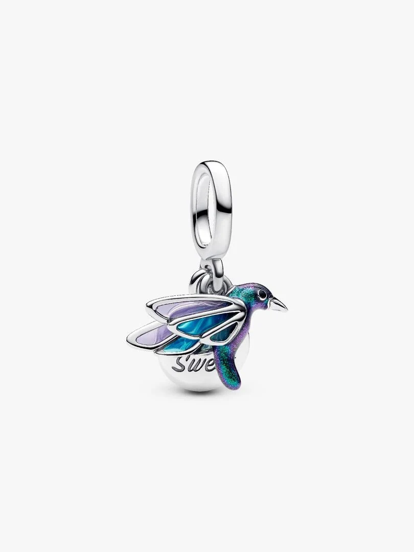 Silver hummingbird charm with blue and purple enamel, side view on a white background.