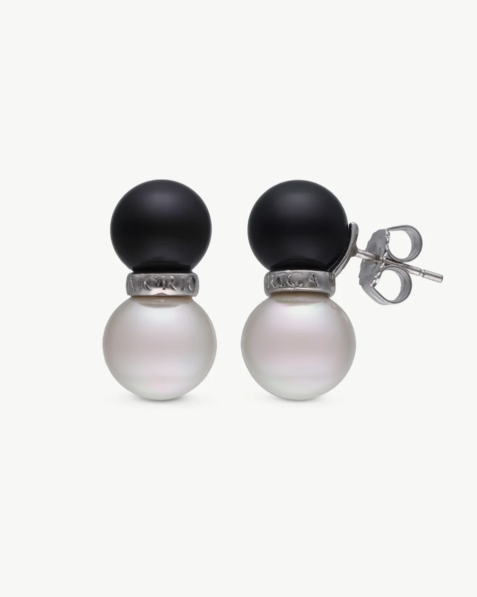 Front view of black and white pearl earrings on a white background, showing the stud closure detail.