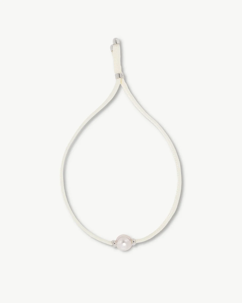White cord bracelet with central pearl, front view on a pure white background.