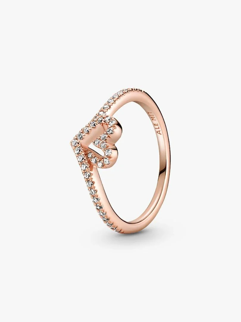 Rose gold ring with heart motif and cubic zirconia, angled side view on a white background.
