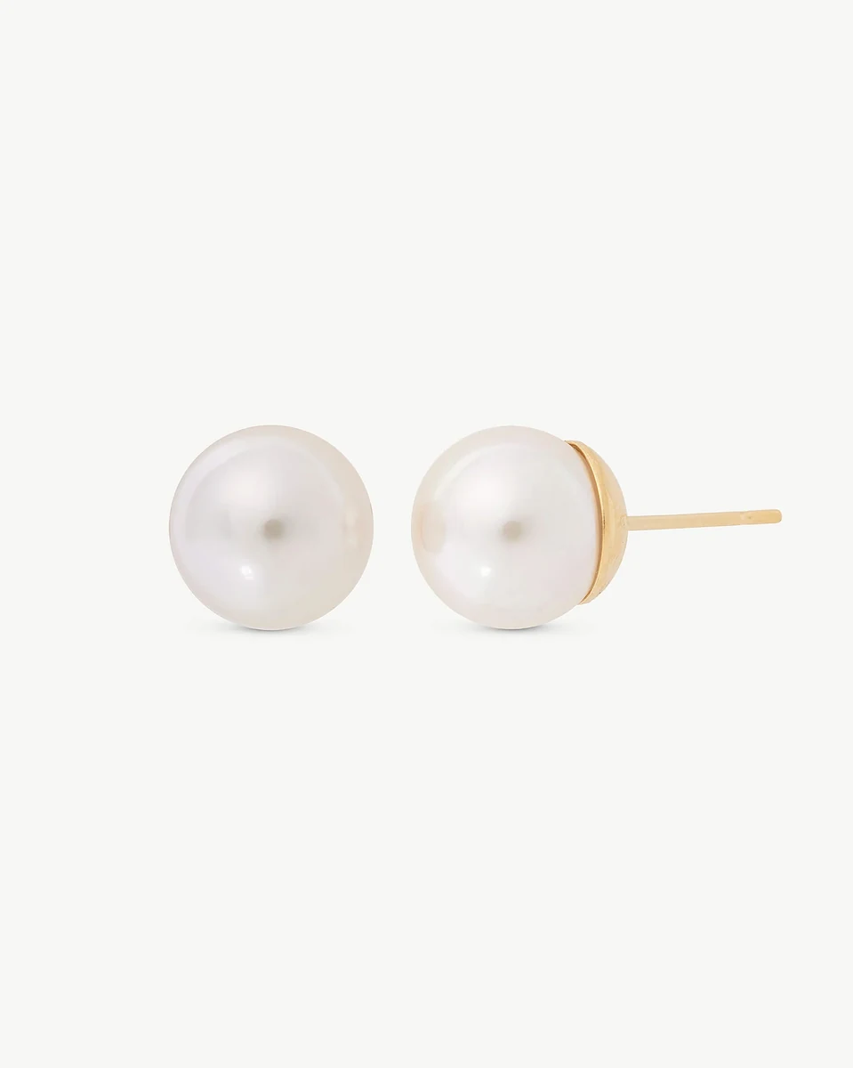 Front view of pearl stud earrings on a white background, showing the gold post from the side.