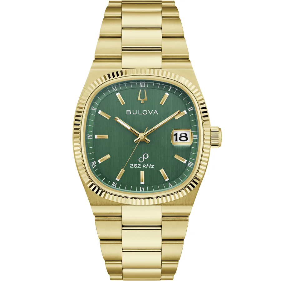 Vista frontal completa del reloj con caja y brazalete chapado en oro, esfera verde, sobre fondo blanco.