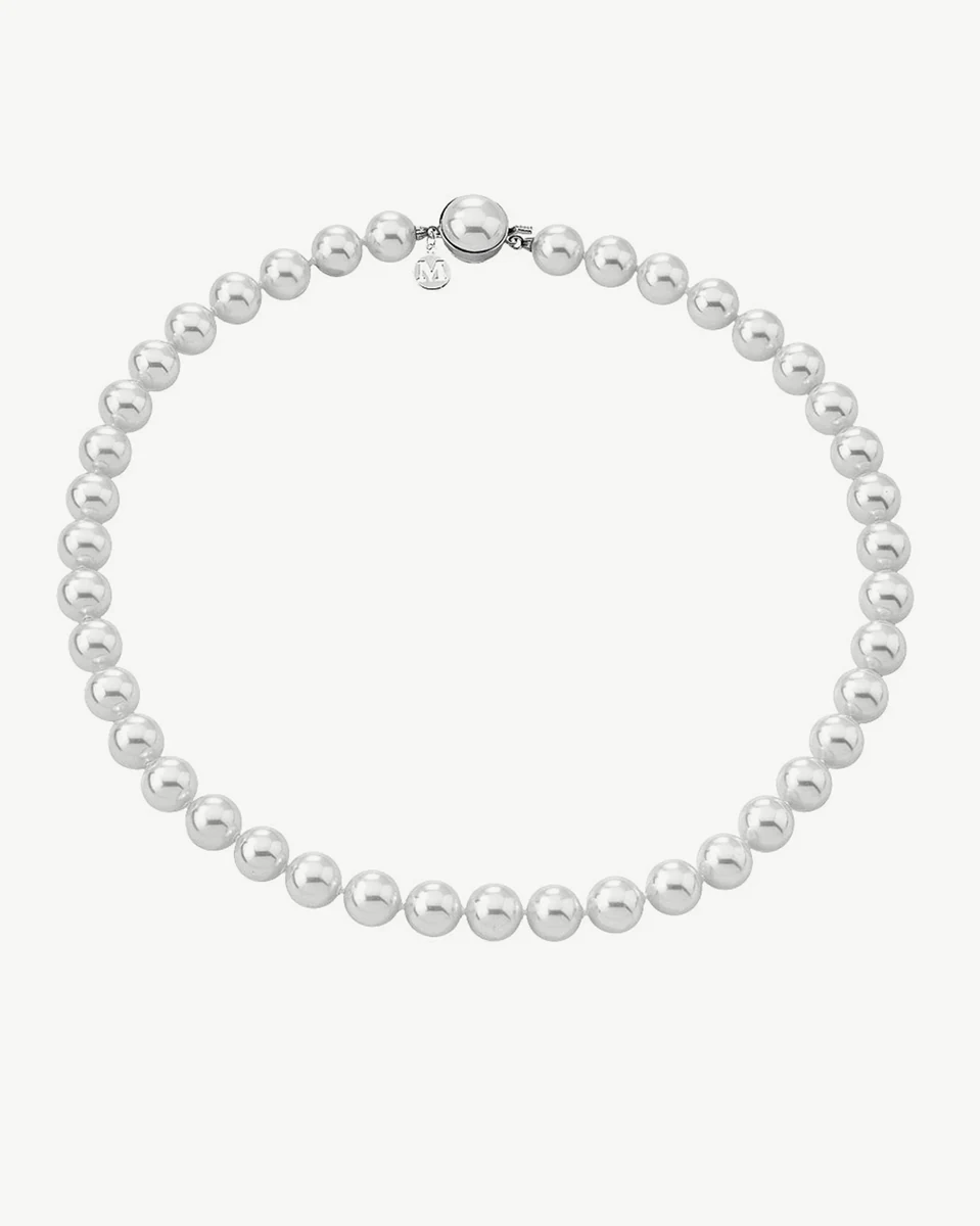 Pearl necklace arranged in a circle on a white background, front view showing the half-pearl clasp detail.