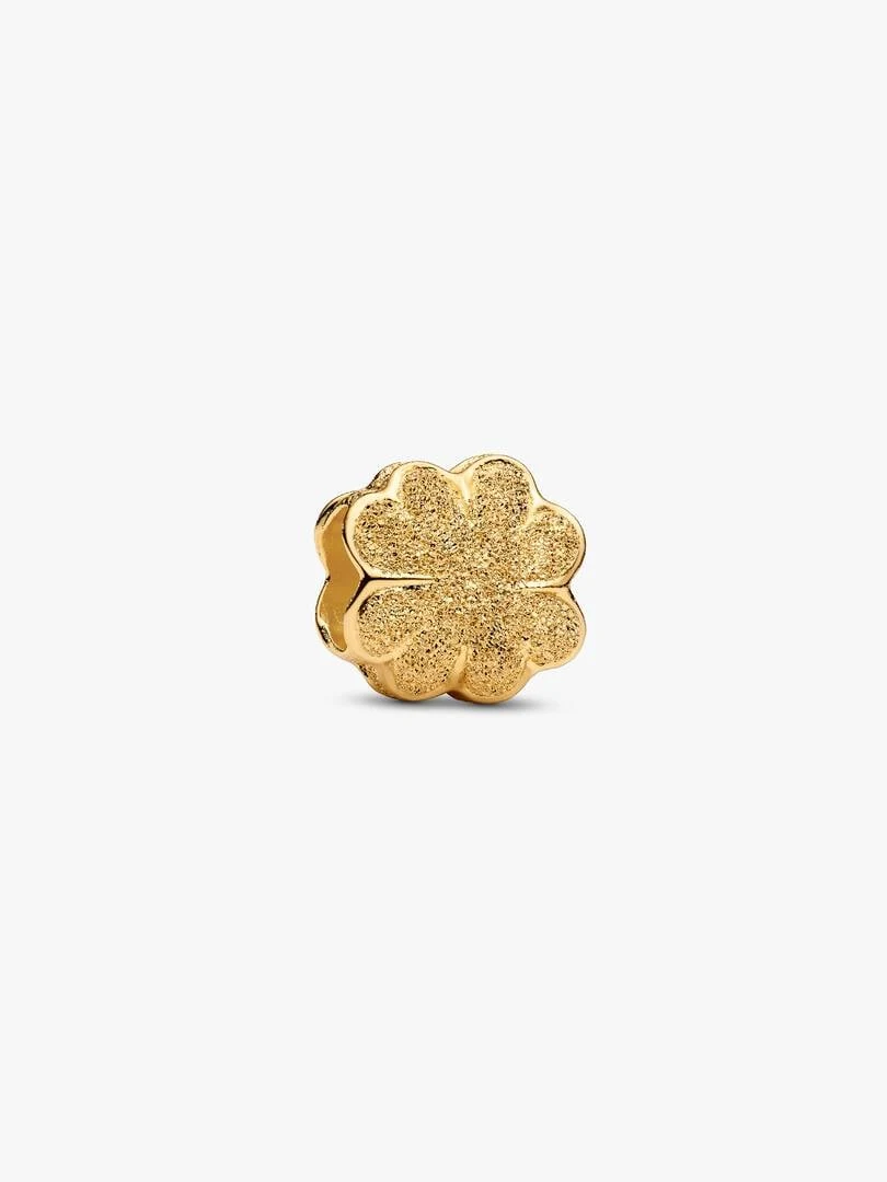 Textured clover charm shown from a side angle, isolated on a neutral white background.