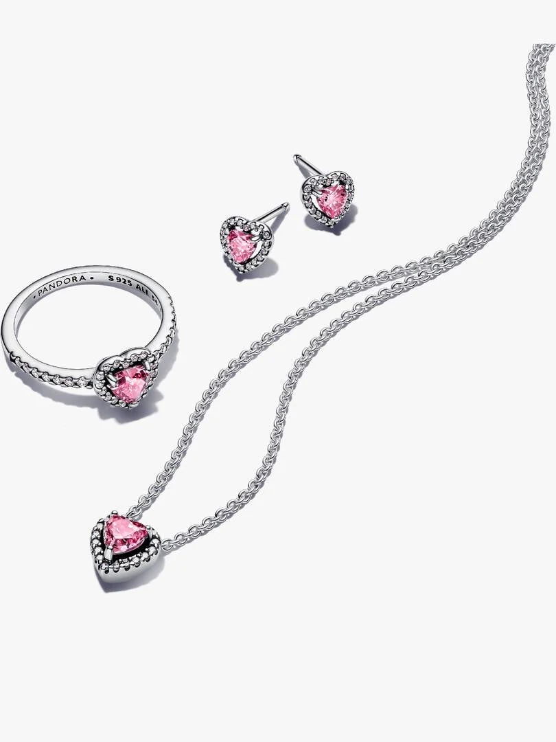 Ring, earrings, and necklace set with pink stones on a white background, top-down view with soft shadows.