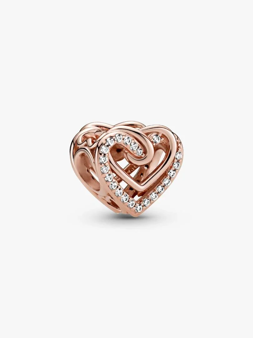Interlocking rose gold heart charm with cubic zirconia, side view on a white background.