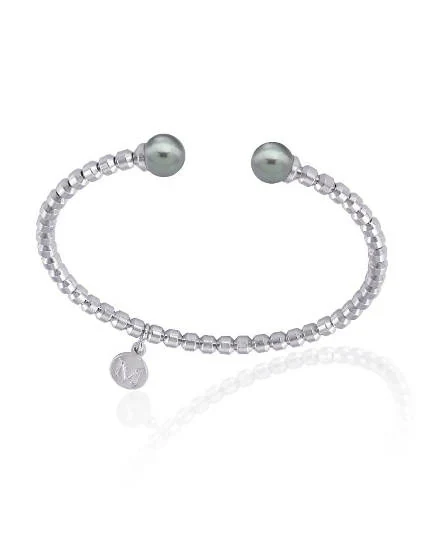 Steel bangle bracelet with two grey pearls, front view on white background with reflection.