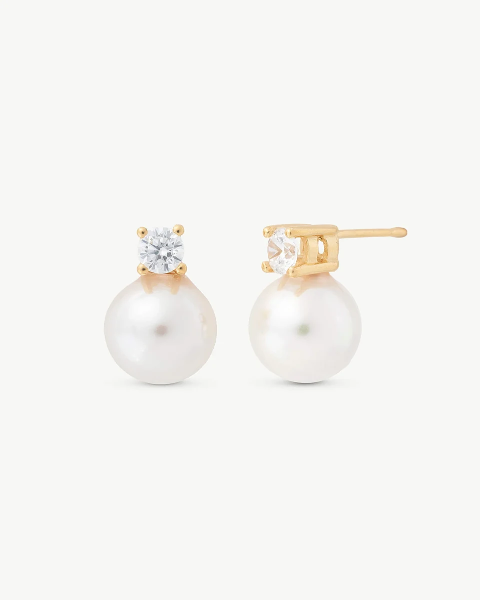 Front view of pearl and cubic zirconia stud earrings on a white background, slight side angle.