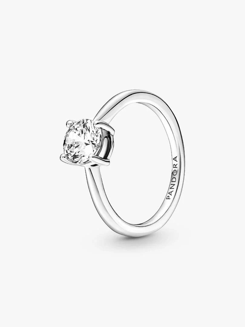Silver solitaire ring with central cubic zirconia, side angle view on a white background.
