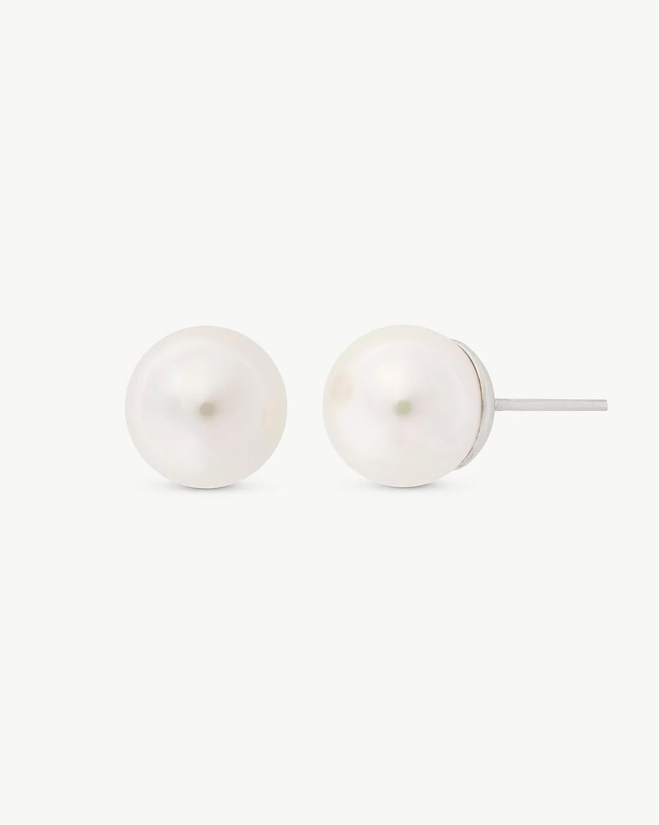 Front view of pearl stud earrings on a white background, showing the silver post from the side.