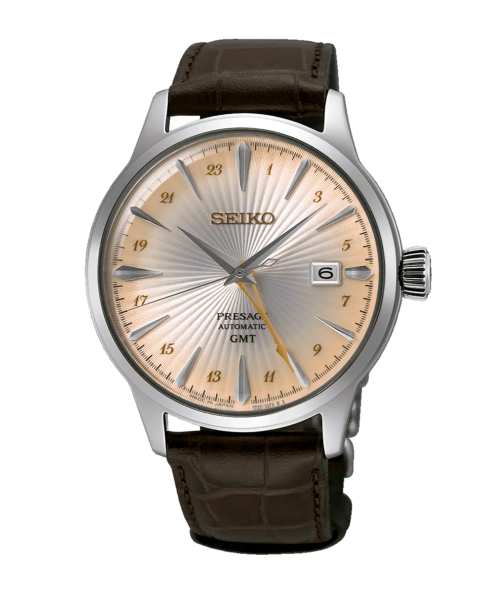 Vista frontal completa del reloj sobre fondo blanco, con correa de piel marrón y esfera de tono champagne