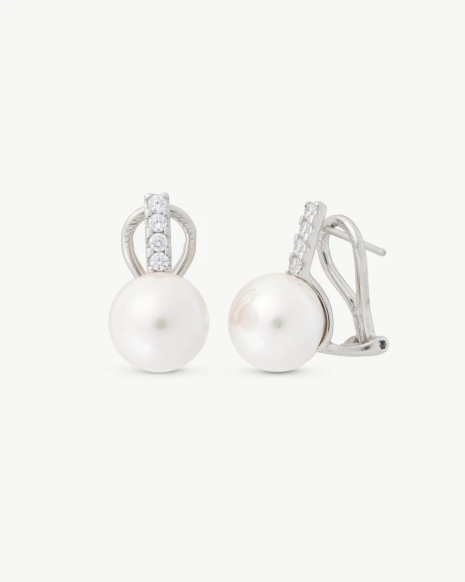 Pair of pearl and cubic zirconia earrings on white background, front and side view.