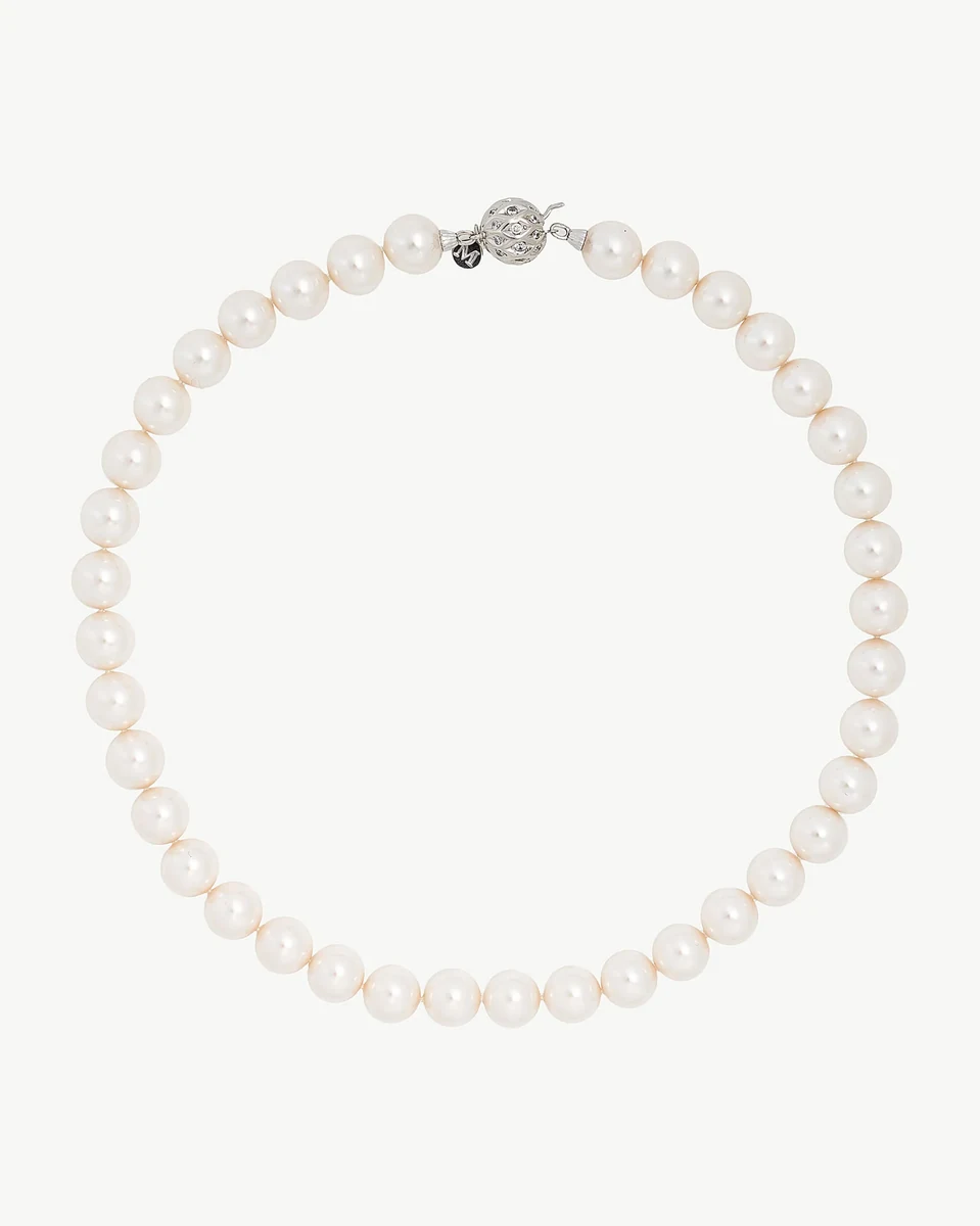 White pearl necklace arranged in a circle on a white background, full frontal view.