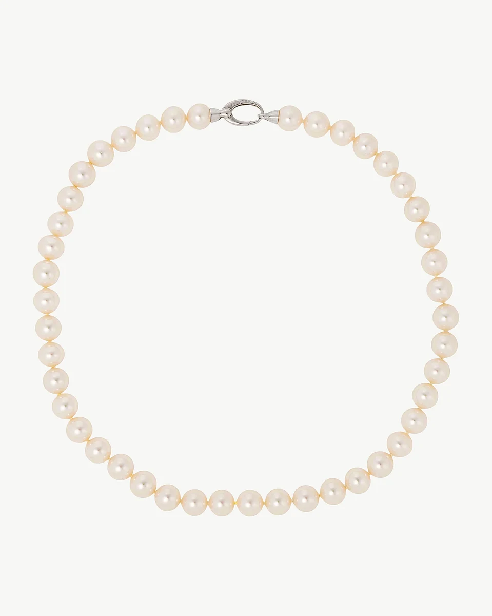 White pearl necklace arranged in a circle on a white background, full frontal view.