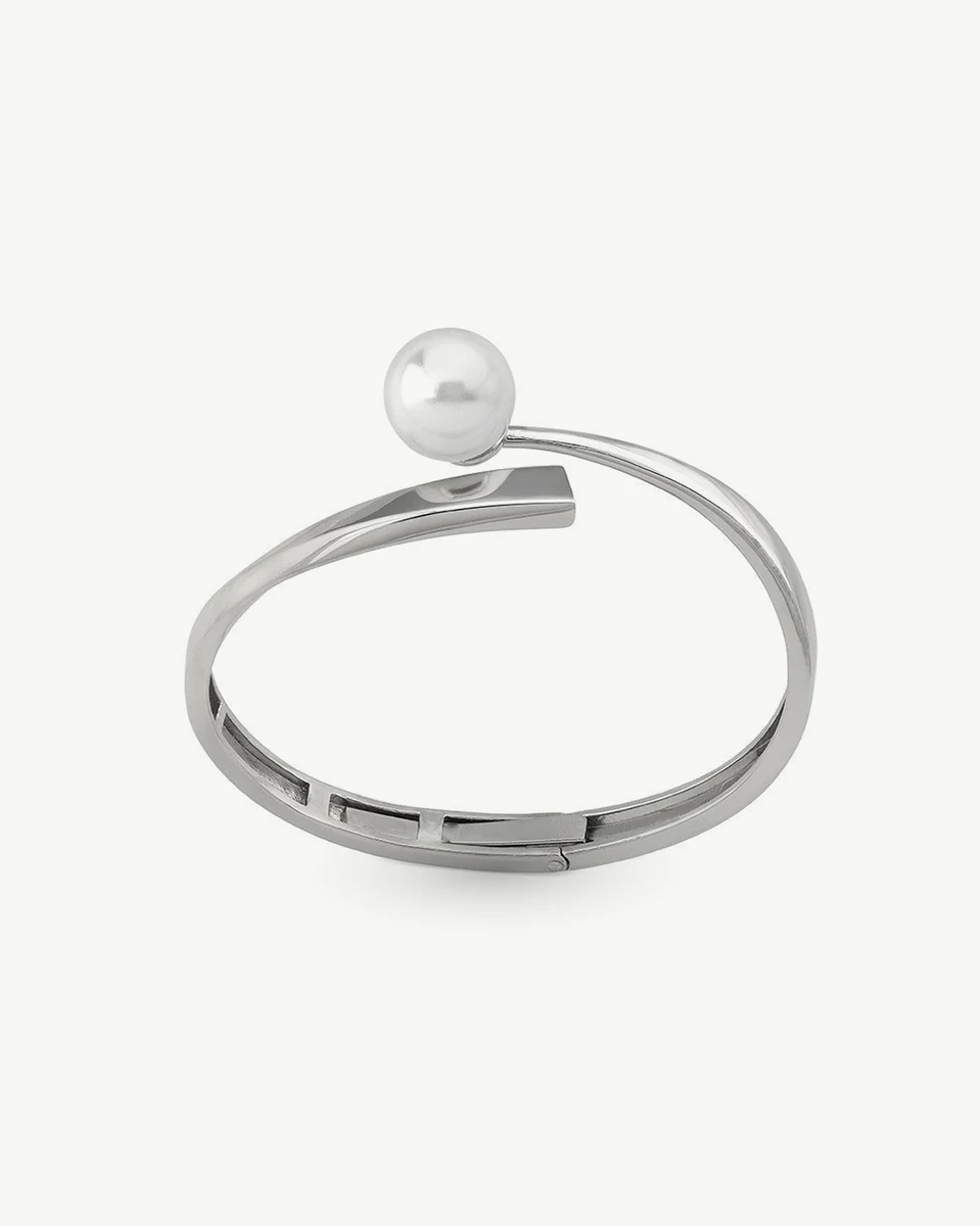 Silver bangle with white pearl, side angle view on a white background.