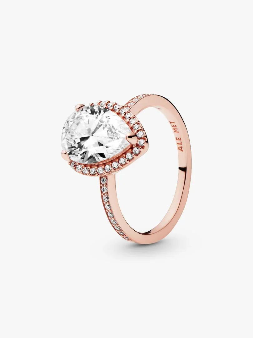 Rose gold ring with pear-shaped center stone, angled side view on a white background.