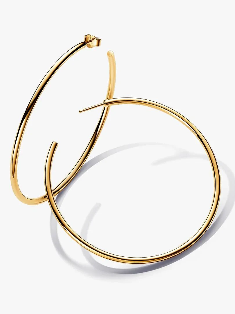 Pair of open hoop earrings with gold finish, angled view on a white background.
