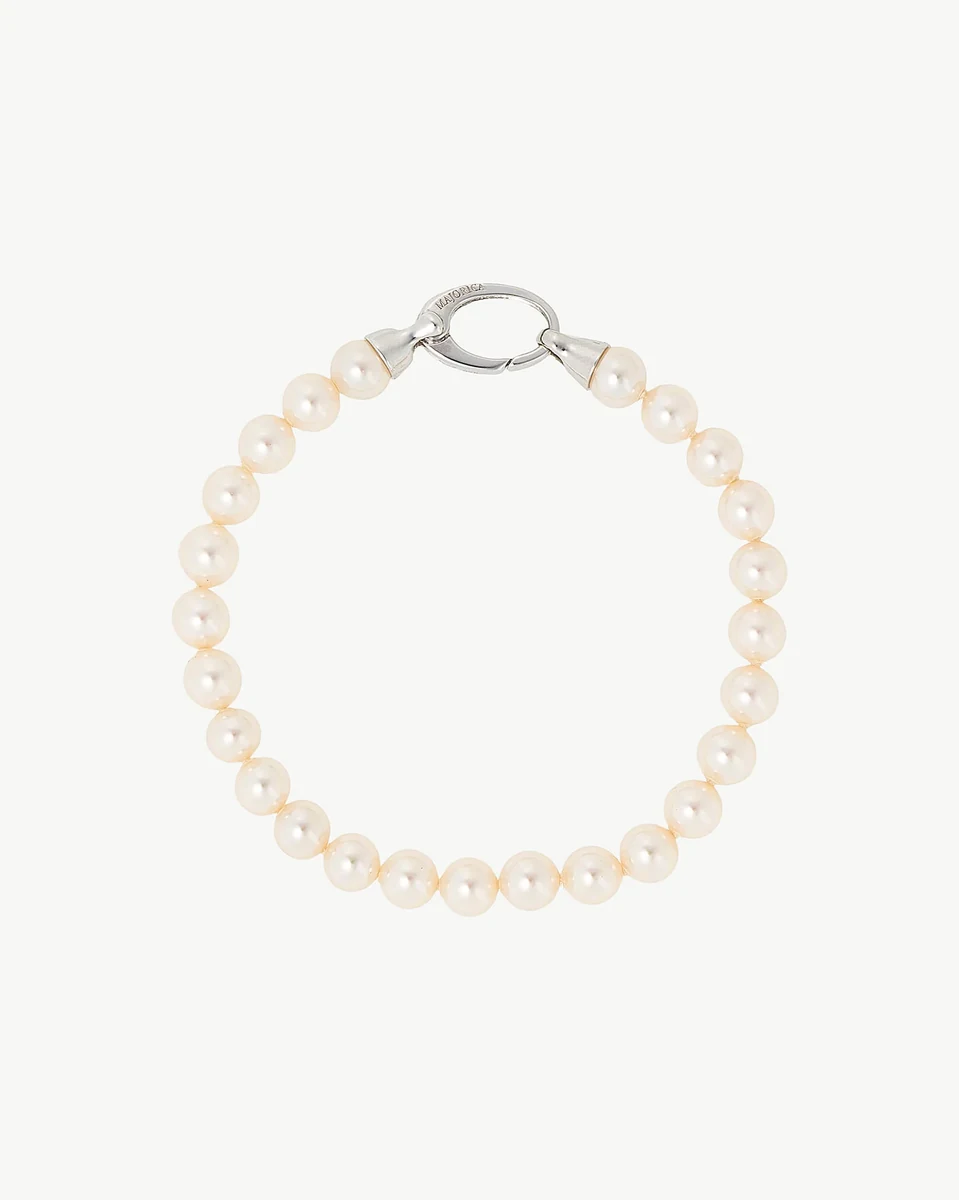 Vue de dessus d'un bracelet en perles formant un cercle, sur fond blanc neutre.