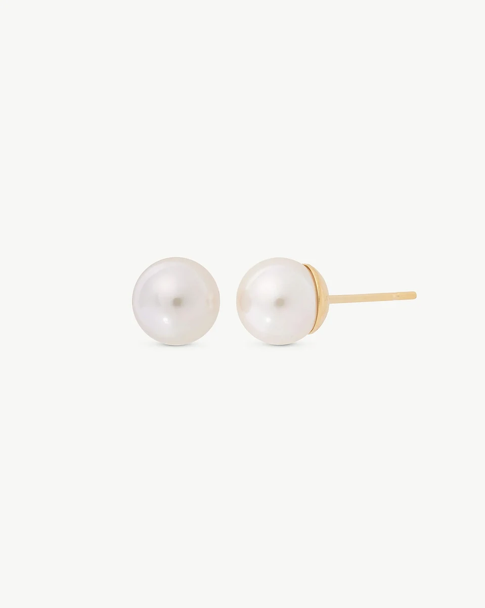 Front view of pearl stud earrings on a white background, showing the gold post from a side angle.